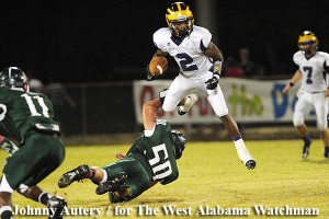Sweet Water running Jakoby Aldridge leaps over Flomaton defensive lineman John Anderson. (Johhny Autery / for The West Alabama Watchman)