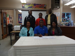 Tyler Davis signed with Alabama A&M Wednesday. He is joined by his mother Teresa Davis (right), aunt Patricia Braxton (left), Linden head coach Andro Williams, his brother Terrance Davis and Linden High principal Dr. Timothy Thurman. 