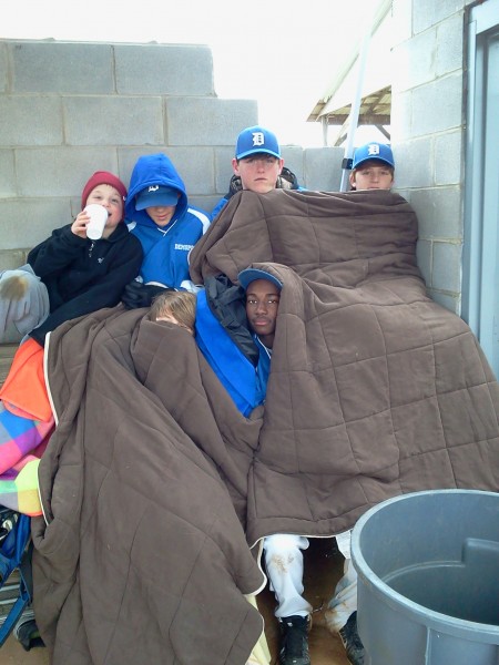 Demopolis Middle School baseball players attempt to stay warm during Saturday's tournament, an event that was played amid freezing temperatures. 