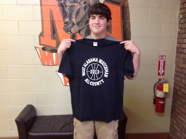 (photo by Raycelia McIntyre) Marengo Academy freshman Cason Cook displays the T-shirt he received recognizing him as a West Alabama Watchman All-County Boys Basketball Team performer.