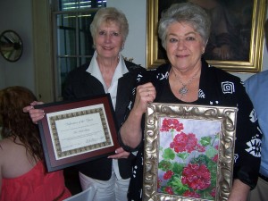 VOLUNTEER OF THE YEAR: Auxiliary President Rebecca Culpepper, left, presents the Volunteer of the Year Award to Ruth Levitz, right.