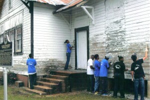  Students from Pickens County work to help restore the exterior of the Pickensville Rosenwald Community Center. The building has been mothballed, discontinuing use until renovation is complete.