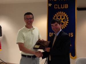 Outgoing Demopolis Rotary Club president Rob Fleming receives from new presdient Rob Pearson a plaque to honor commemorate his year of service atop the organization.