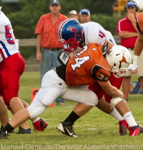 Brant Lewis (34) stops a South Choctaw Rebel behind the line of scrimmage in first quarter action.