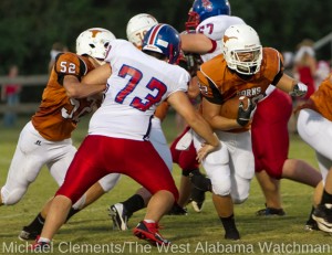 Josh Holified (22) breaks through the line with help from a block by Hayden Hall (52).