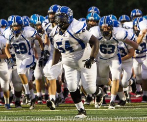 Hollis Bright (54) leads his team onto the field before a game during the 2013 season. 