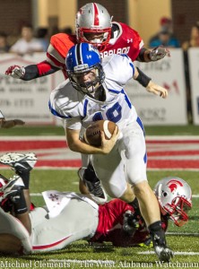 Tyler Oates avoids a couple of would-be tacklers on a run against the Saraland High School Spartans.
