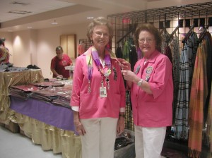 Rachel Lamb, left, and Alice Washburn show off some of the items offered for sale during last year’s event.