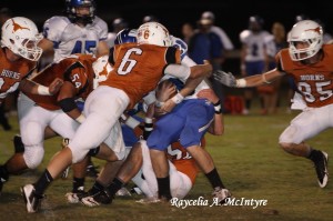 Tyler Barkley, #6, Carson Huckabee, #50, Tate Sanford #54 and several other Longhorns saw action on this tackle.