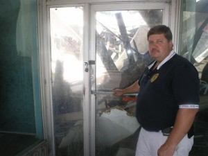 Linden Police Chief Scott McClure inspects the water damage to the former Levy Department Store.