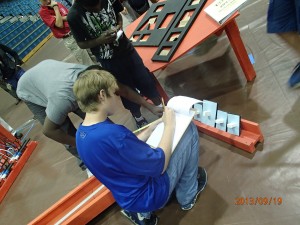 Ben Robertson takes notes as his Demopolis Middle School team learns of its challenge in the BEST robotics competition. 