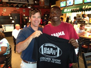 ESPN 104.9 Coaches Show co-host Rob Pearson presents Demopolis High running back Roderick Davis with a commemorative T-shirt for earning Player of the Week Tuesday at Batter Up.