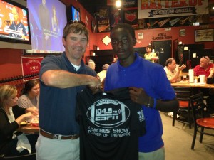 Linden quarterback D.J. Charleston receives a commemorative Player of the Week T-shirt from ESPN 104.9 Coaches Show co-host Rob Pearson Tuesday at Batter Up Sports Grill in Demopolis. 