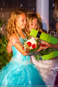 Buckley Nettles is congratulated by Sarah Kate Potter, after Buckley was named 2013 Young Miss Christmas on the River.