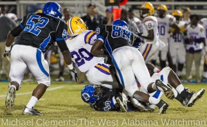 Tyler Merriweather (40) ad Rahmeel Cook (88) bring down a Jackson runner as Jacquan Lawson (52) closes in.