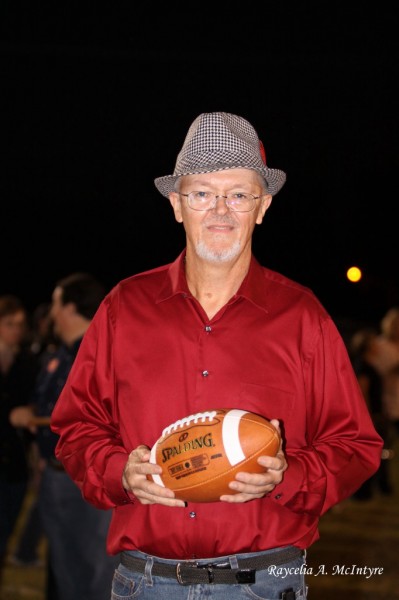 Mr. Lee Bozeman, former band director, presents the game ball. 