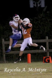 Andrew Martin leaps through the air to intercept a pass at the one yard line.