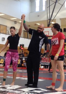 Ronda Russell's hand is raised in victory after winning the women's featherweight expert no gi championship at the NAGA Southeast Regional Championships in Atlanta, GA.