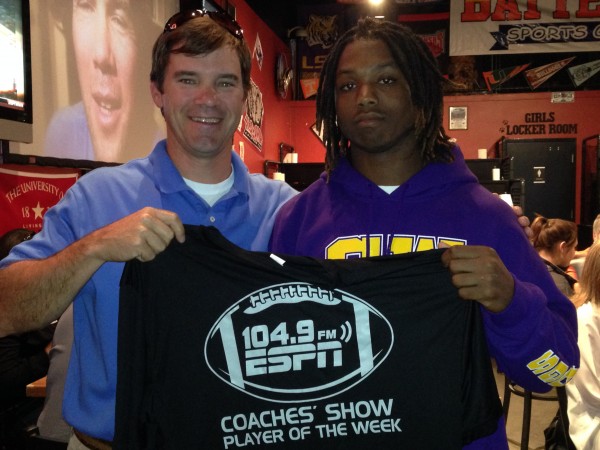 Sweet Water senior running back Jakoby Aldridge receives a T-shirt from ESPN 104.9 Coaches Show host Rob Pearson last Tuesday night at Batter Up. Aldridge is the ESPN 104.9 Player of the Week. 