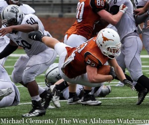 Josh Holifield dives for a Longhorn first down against Restoration Academy.
