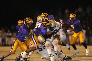 Kyle Patterson (56) stuffs DeAnthony Holcombe Friday night. 