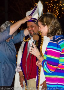 COTR 2012's Saint Nicholas, Kelley Tarpley (left), crowns J.R. Rivas (center) as Saint Nicholas for COTR 2013 as Katie Windham (right) speaks during the coronation Thursday evening.