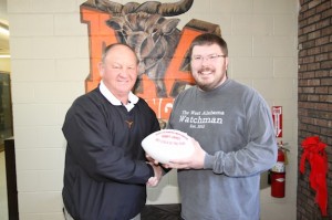 Marengo Academy coach Robby James receives a commemorative Coach of the Year football from West Alabama Watchman managing partner Jeremy Smith. 