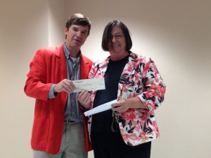 Demopolis Rotary Club President Rob Pearson presents a check for $100 to Ellen Wallace of the Marengo County DHR. 