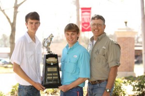 UWA students Andrew Warbington and Mitch Brumbeloe are proud to hold the trophy they brought back to Livingston after Sunday's Carhartt Bassmaster College Classic. The UWA Tiger Bass Club is coached by UWA staff member Doyle Truelove (right).