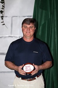 Danny Stenz shows off his commemorative mini-basketball for having earned West Alabama Watchman Girls Basketball Coach of the Year for the 2013-2014 season. 