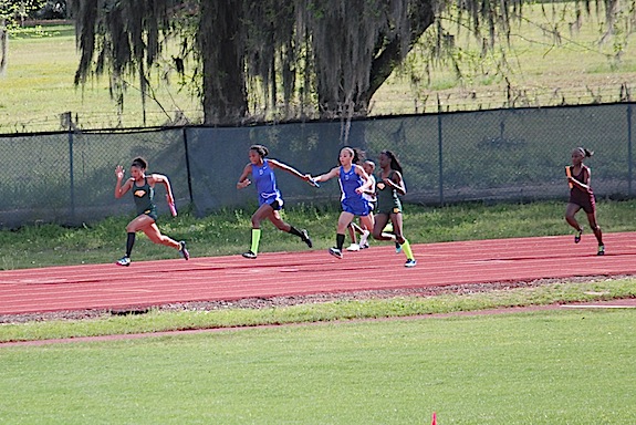 Darnesha Harris receiving the baton from Sylvia Clayton in the girls 4x100-meter relay.