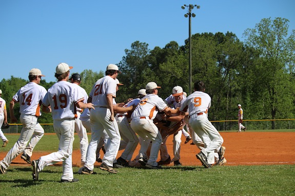 (Photos by Collin Sheffield)  The Longhorns swarm Wallace Tutt in celebration following his walk-off game-winner over Cornerstone Friday.
