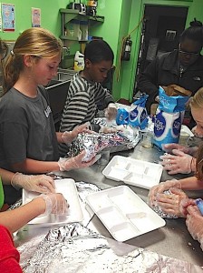 U.S. Jones enrichment students wrap and store cookie dough.