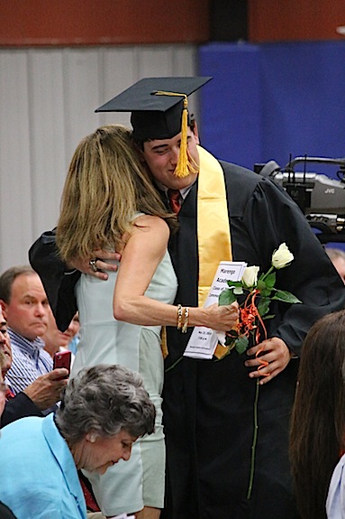 William Tutt gives his mother a hug during the Rose Ceremony