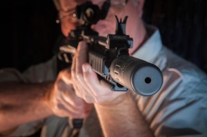 Firearms suppressors, like the one shown by Doug Williamson at The Gun Shoppe in Montgomery, are now legal for hunting in Alabama as long as the hunter has legally purchased the suppressor and carries the federal tax stamp required for all such devices. 