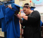 Senior sponsor Jessica Skelly helps Porcha Hill ready for graduation.