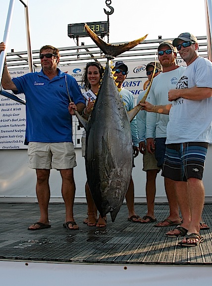 The crew of Blue Smoker, another Orange Beach boat, celebrates the winning 173.3-pound yellowfin tuna.