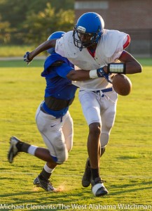 Davontae May (blue jersey) strips the ball from Charles Tripp (white jersey) during the Tigers' Thursday scrimmage.