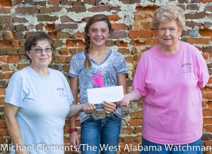 Bigbee Humane Society Thrift Shop volunteers Kathy Wilson (left) and Virginia Overstreet (right) accept a donation for the Bigbee Humane Society from Sally Mackey (center).