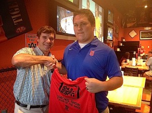 ESPN 104.9 Coaches Show Rob Pearson presents Blaine Winsett of Sumter Academy with a commemorative Player of the Week T-shirt.