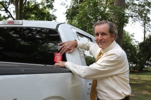 UWA President John G. Blackwell assists with "30k in 30 Days - The UWA Roadway Challenge" by placing a UWA decal on a participant's back window. Blackwell said the overall goal for the initiative is to encourage students, faculty, staff, and friends to show support for the University of West Alabama.