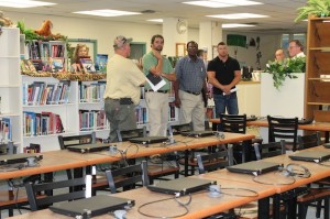 The capital committee looks at the changes in the Demopolis Middle School library.