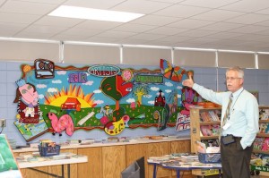 Leon Clark shows off a mural at U.S. Jones Elementary School.