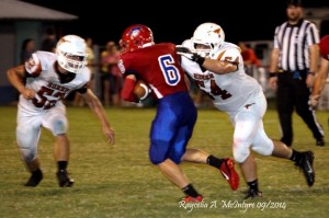 Hayden Hall #52 blocks the way as #54 Tait Sanford goes for the take down.