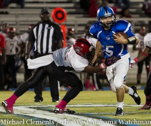 Logan McVay breaks a tackle and looks for a block against Sumter Central.