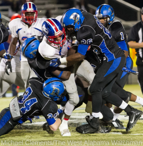Drew jones (34), Rahmeel Cook and Marcus Wright (26) bring down a Wilcox Central runner. Tim Bonner was also in on the stop (back).
