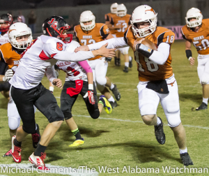 Hayden Huckabee deflects the arm of a would-be tackler on touchdown run against Jackson Academy.