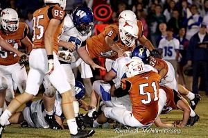 Thomas Etheridge (51) pulls down a Wilcox ball carrier as Tyler Barkley (6) comes over the top to help finish the play.