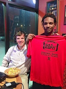 A.L. Johnson senior safety Jeremy Mitchell with ESPN 104.9 Coaches Show host Rob Pearson.