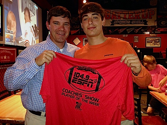 Hayden Hall receives a commemorative Player of the Week T-shirt from ESPN 104.9 Coaches Show host Rob Pearson Tuesday at Batter Up Sports Grill in Demopolis.